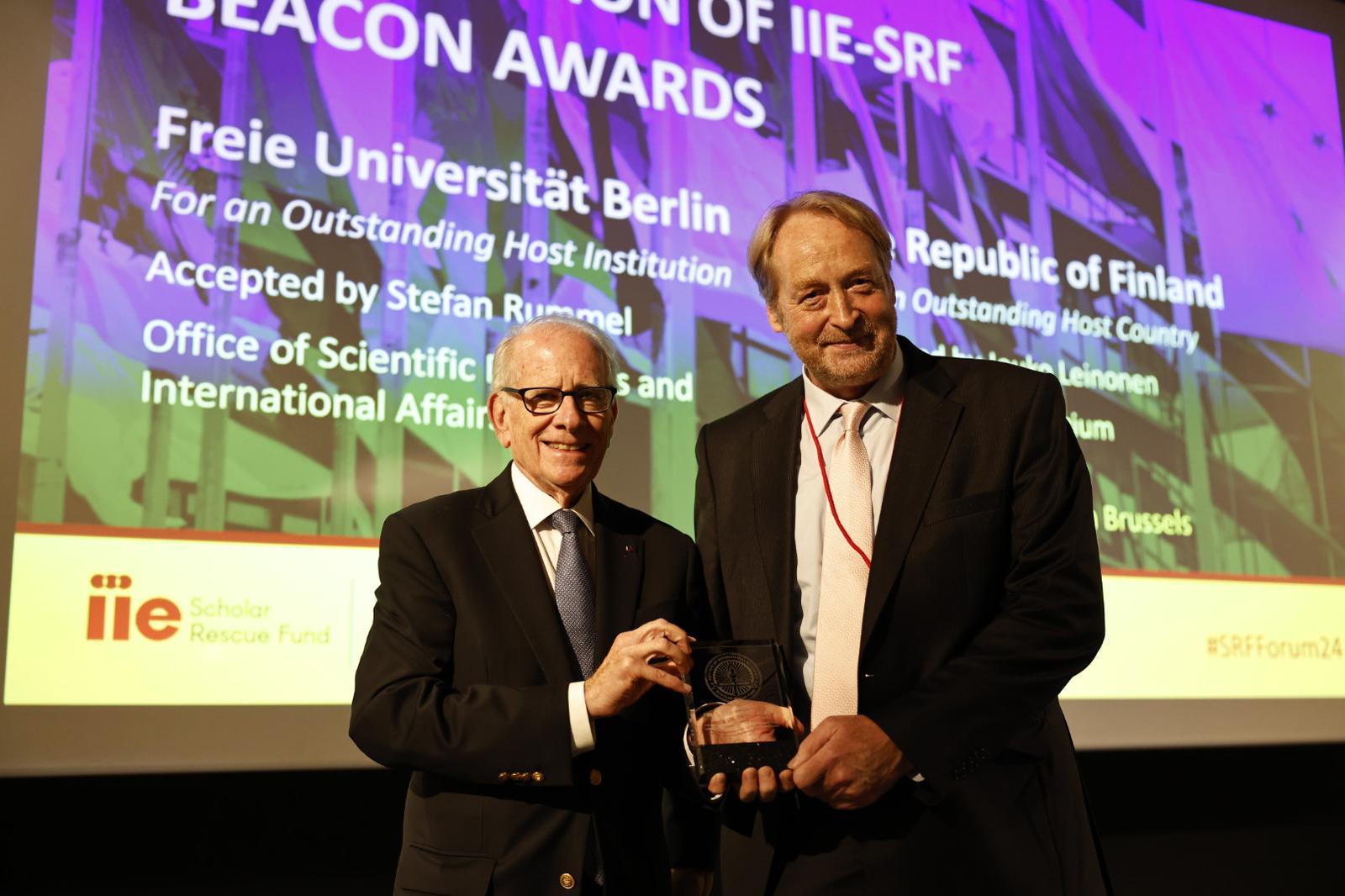 Stefan Rummel, head of Freie Universität’s Academic Relations Unit, accepts the Beacon Award on behalf of the university at an event in Brussels.